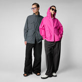 A man and a woman showcasing SaveTheDuck's animal-friendly and sustainable jackets, with the man in a grey jacket and the woman in a bright pink jacket. | Save The Duck | Animal Free Elegant Duvets for Men and Women