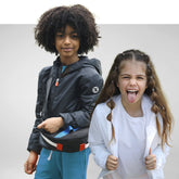 Two children wearing eco-friendly jackets, one in black and the other in white, with playful expressions | Save The Duck