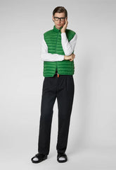 Man wearing green recycled polyester vest with white shirt and black pants | Save The Duck | Animal Free Elegant Duvets for Men and Women