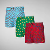 Three pairs of patterned swim trunks in blue, green, and red with playful designs | Save The Duck | Animal Free Elegant Duvets for Men and Women