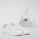Elegant white sneakers with a subtle pink accent on the heel, presented next to a glossy white SaveTheDuck tote bag with a colorful rainbow logo, illustrating fashionable, eco-conscious accessories. | Save The Duck | Animal Free Elegant Duvets for Men and Women